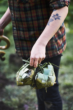 Moique Fiso taking food baskets out of the Hangi pit for her Hiakai pop up dinner by Monique Fiso.