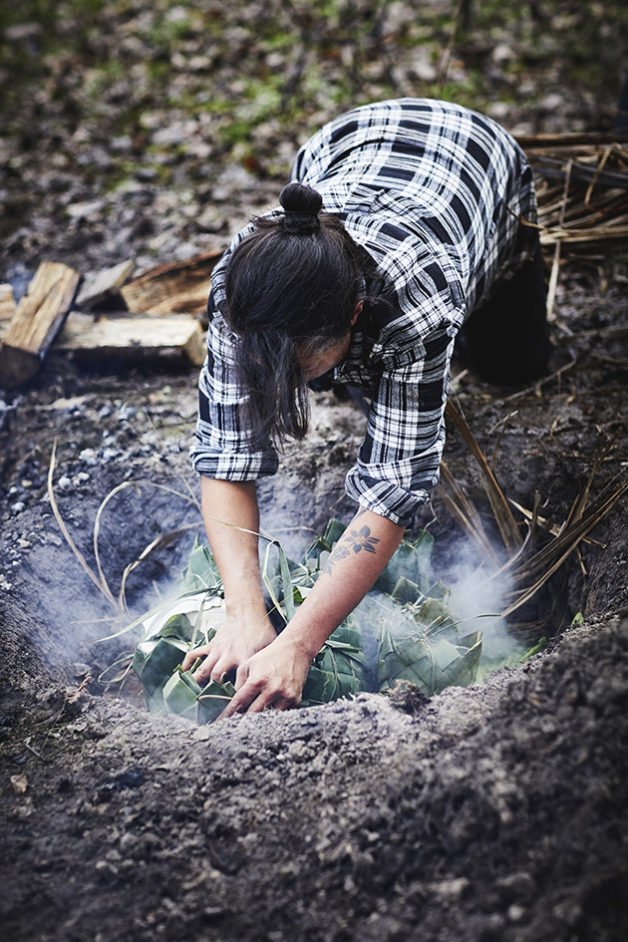 Moique Fiso loading up the Hangi pit for her Hiakai pop up dinner by Monique Fiso.